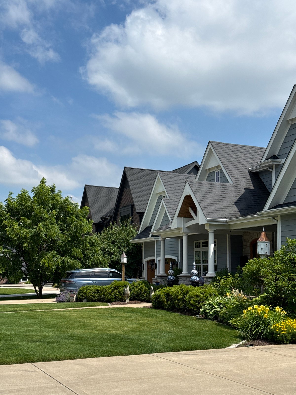 Multi-story home with blue siding and gabled dormers in Naperville