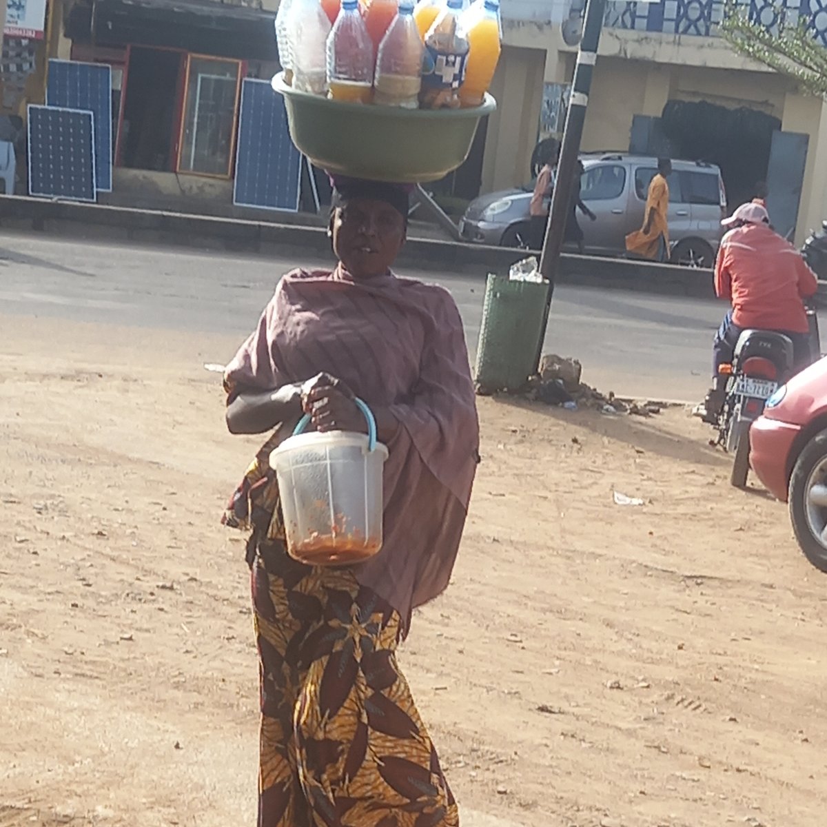 Daily street life documented in Nigerian towns during afternoon