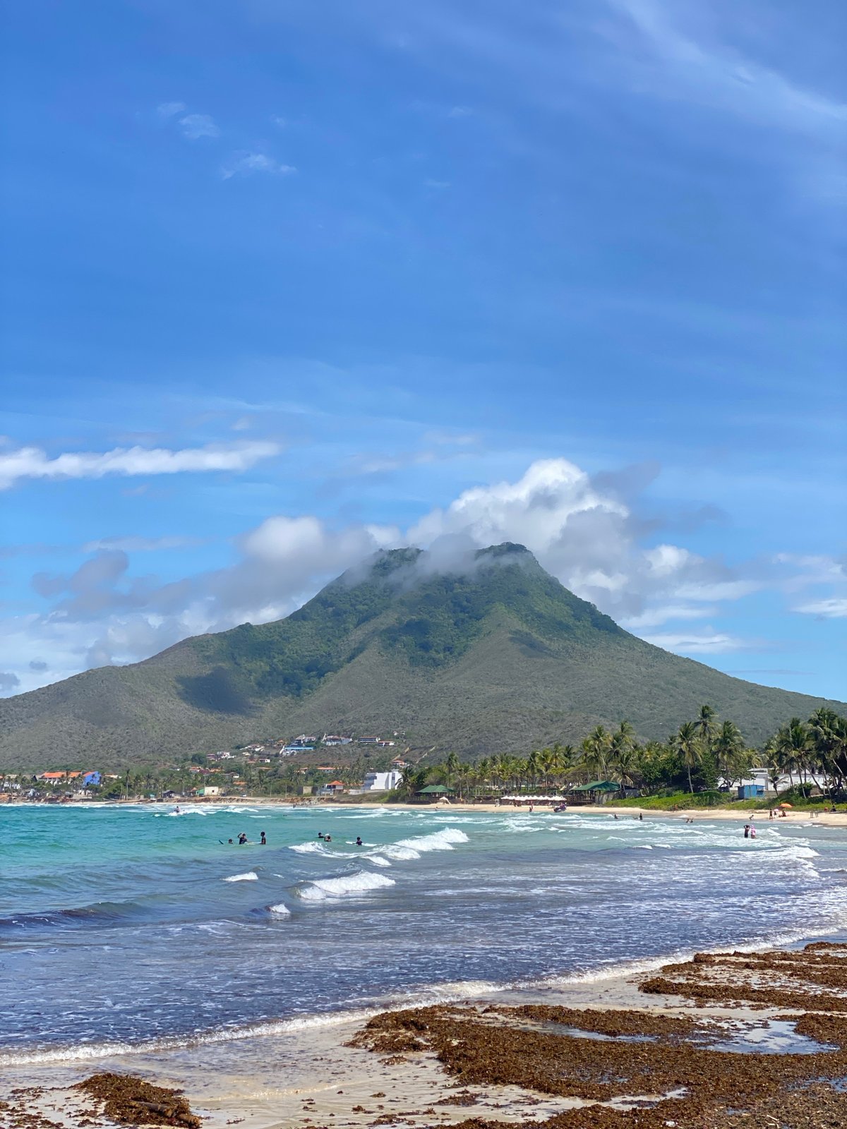 Colorful fishing boats line the shore at El Tirano beach