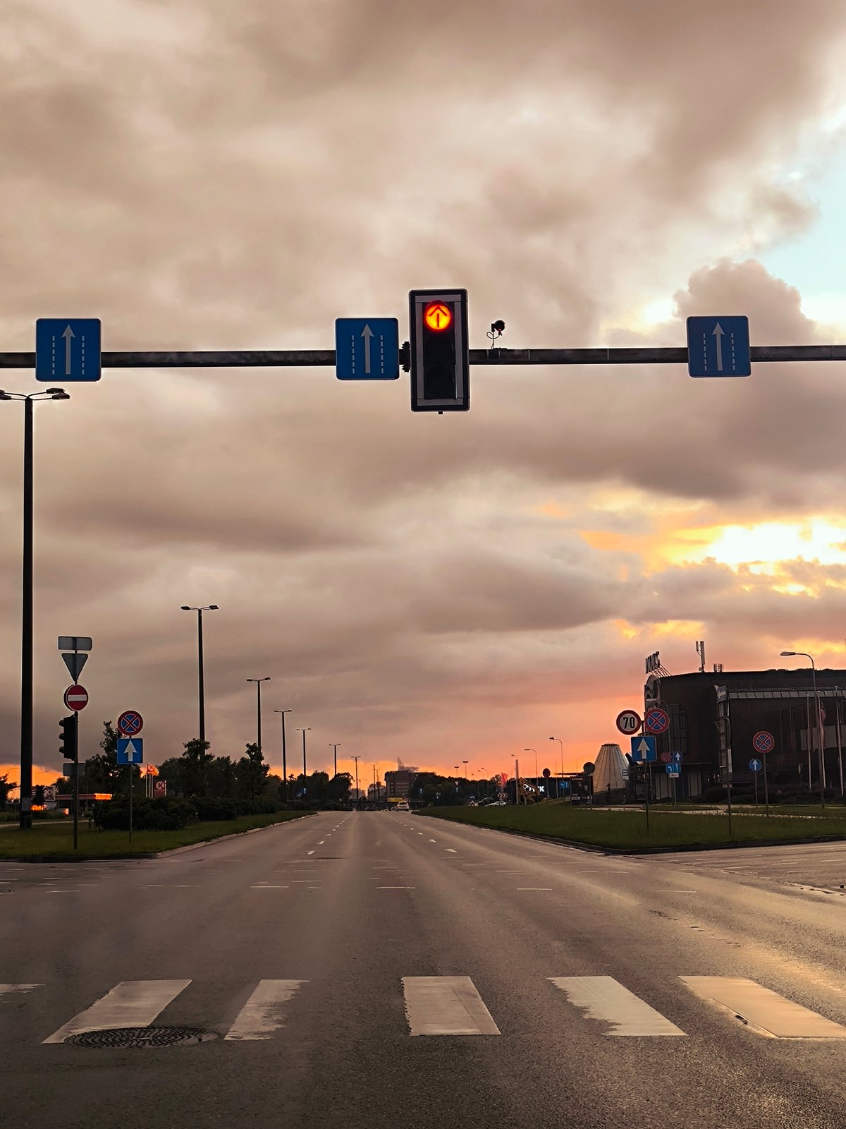Riga intersection at sunset, red arrow signal glowing