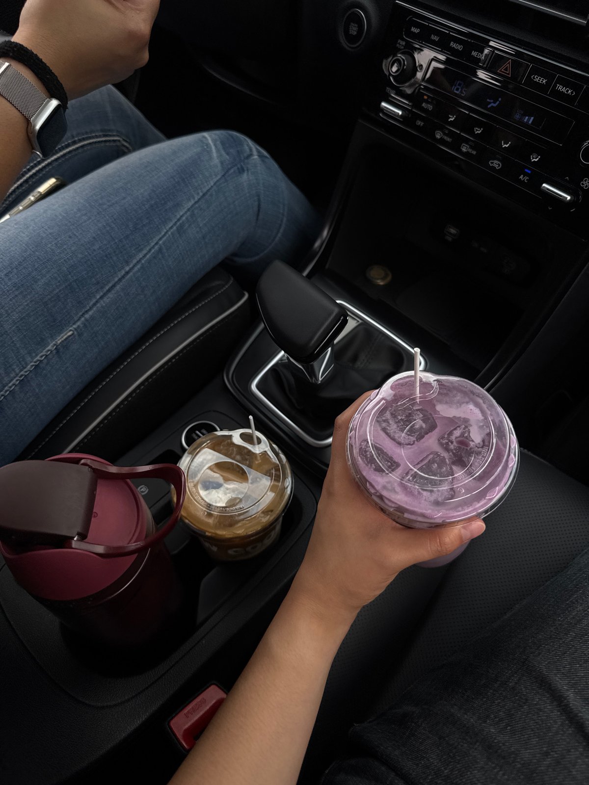 Person enjoys Woods-branded beverage inside car in Puebla