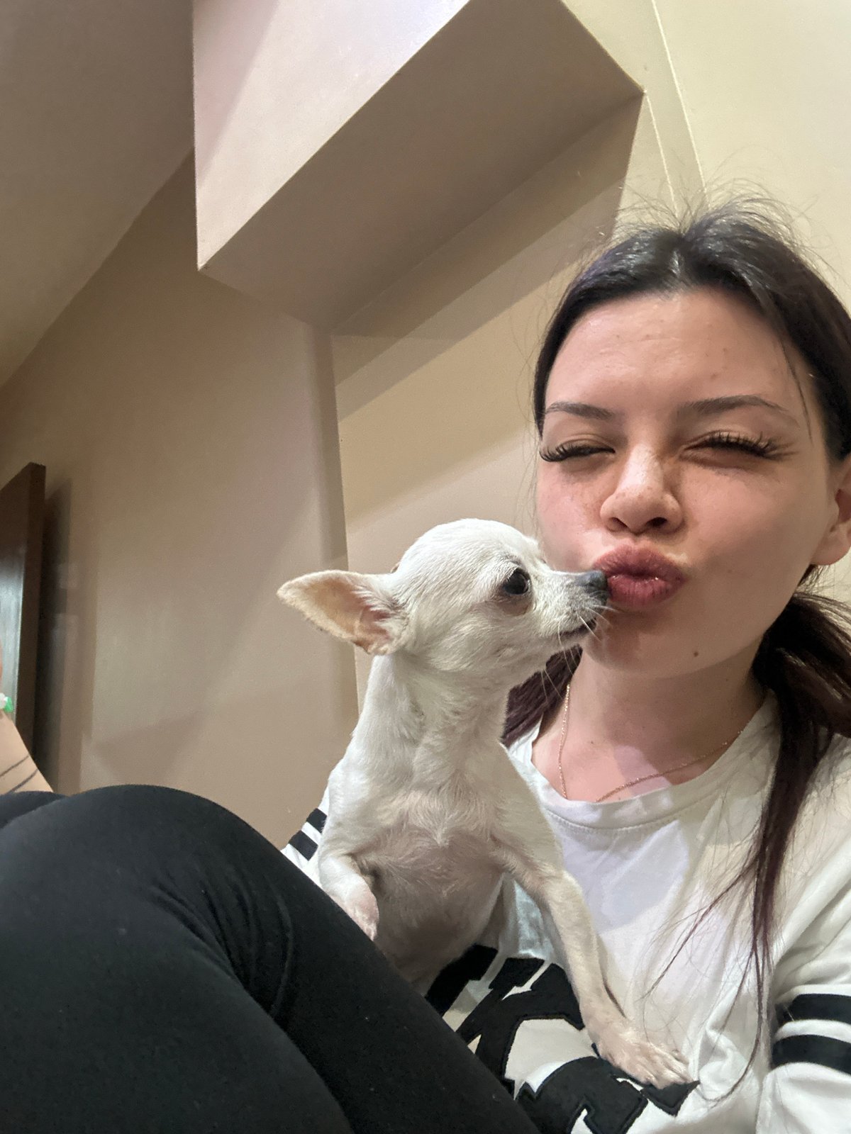 Woman photographed with white dog in Sliven, Bulgaria