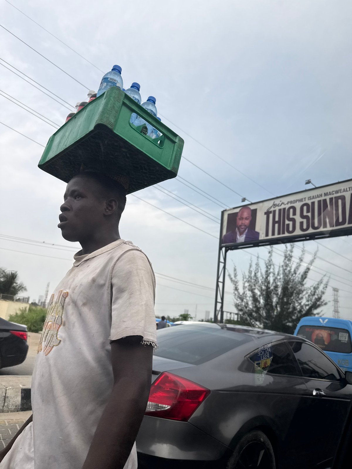 Man carries goods on head in Alaguntan, Nigeria