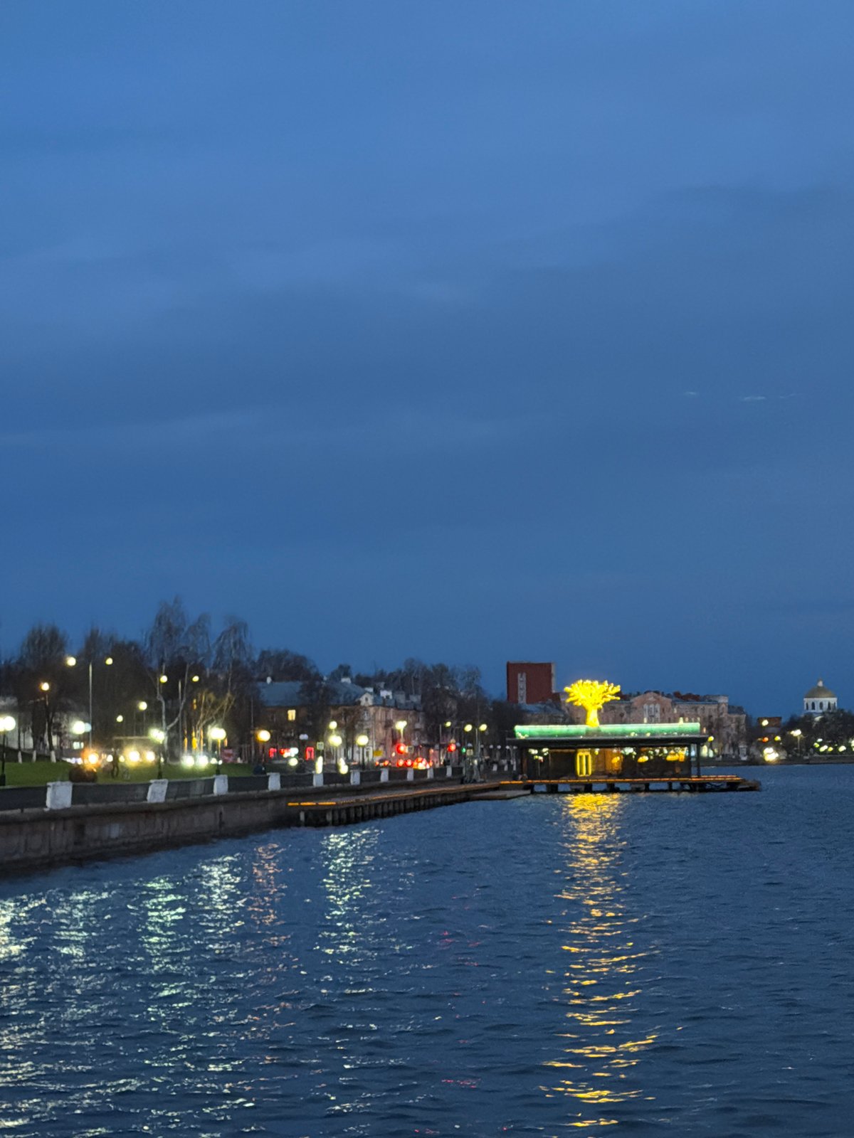 Family enjoys evening waterfront stroll in Votkinsk, Russia