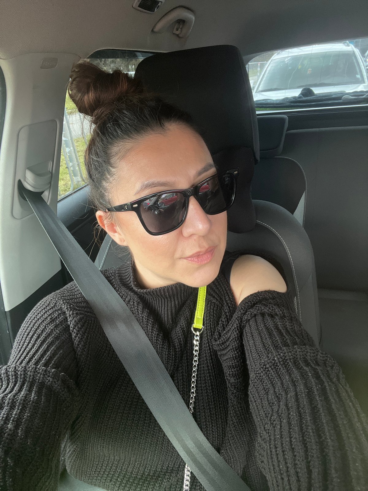 Woman in sunglasses observed seated in car in Varna