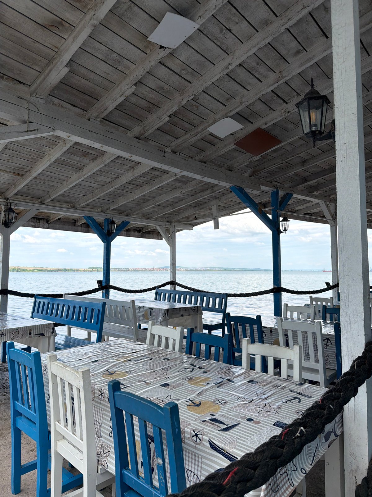 Tourist documents peaceful Burgas waterfront scene with restaurants, marina