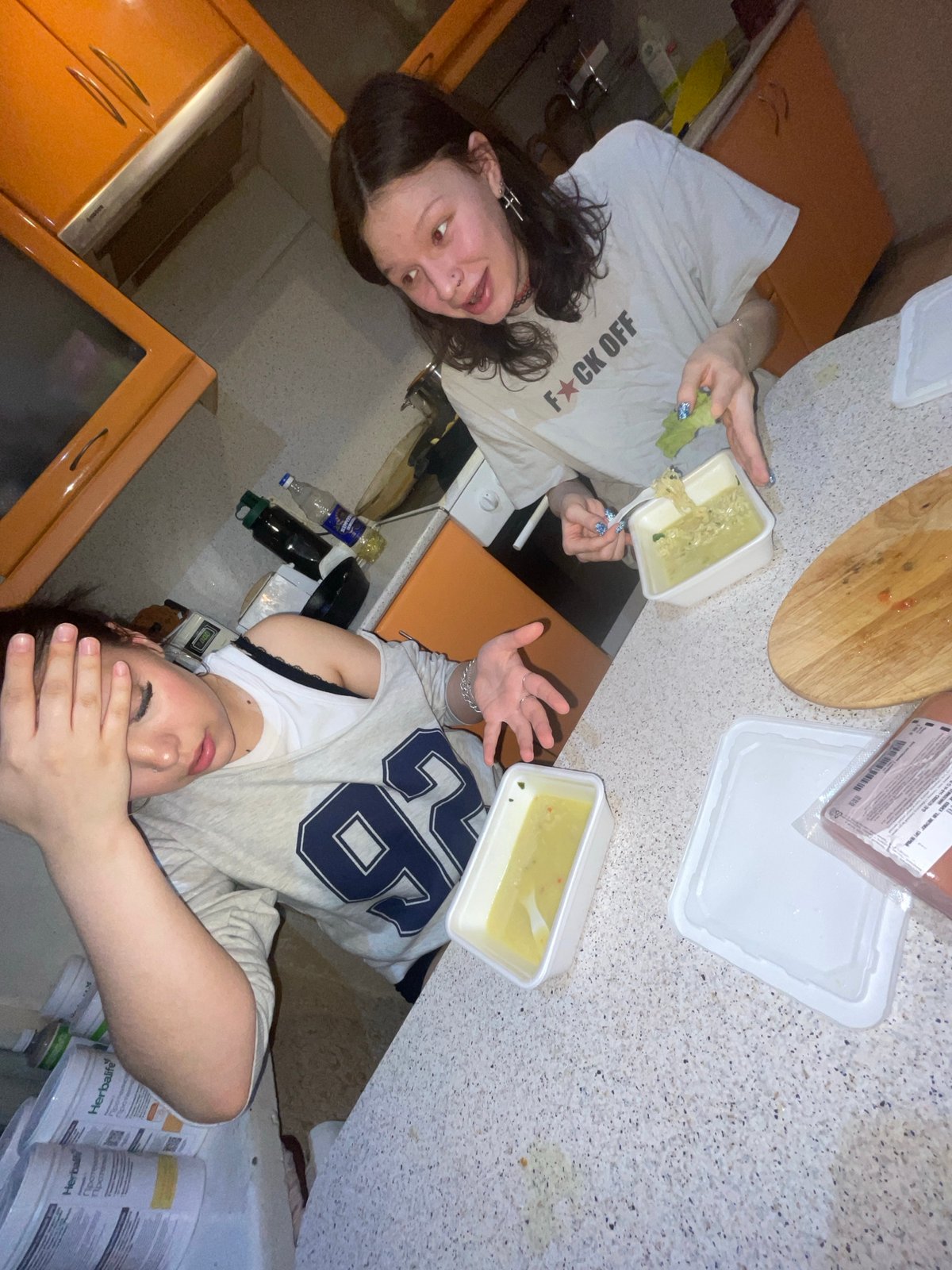 Two women photographed in Russian apartment kitchen setting