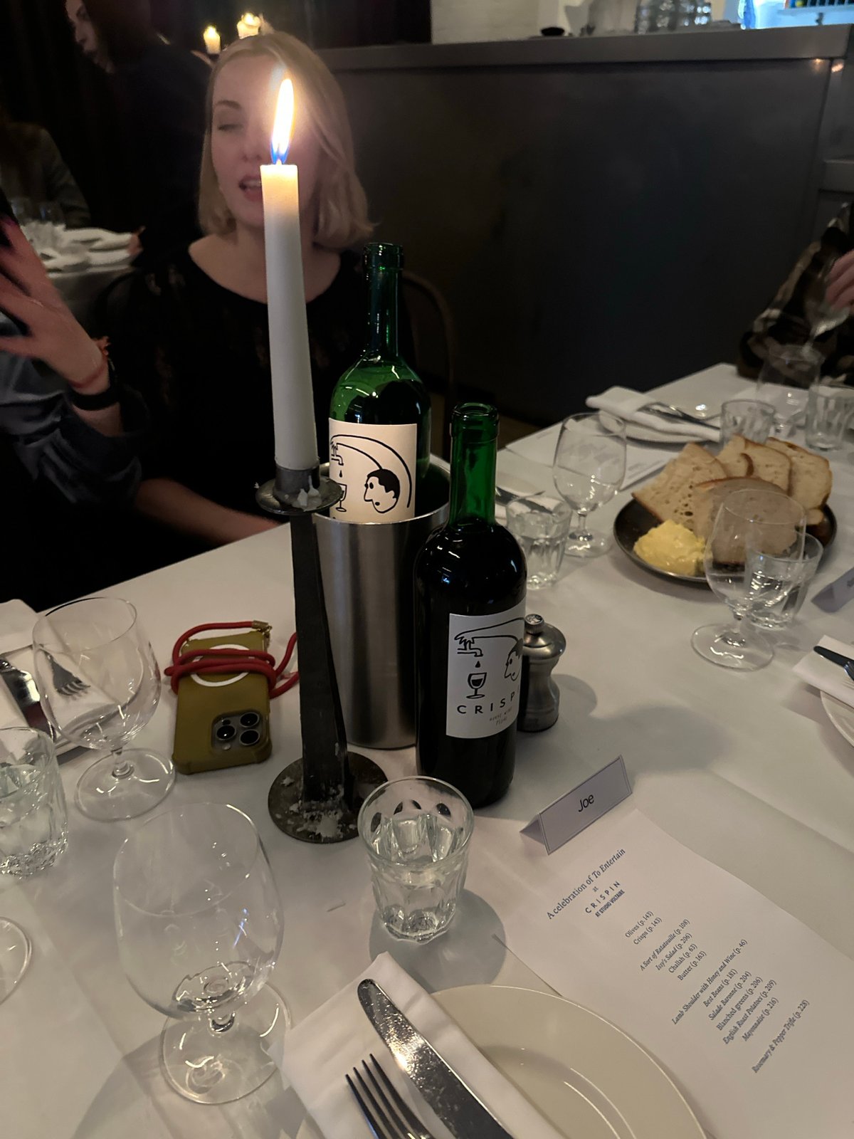 Evening dinner gathering at London restaurant features formal dining, wine