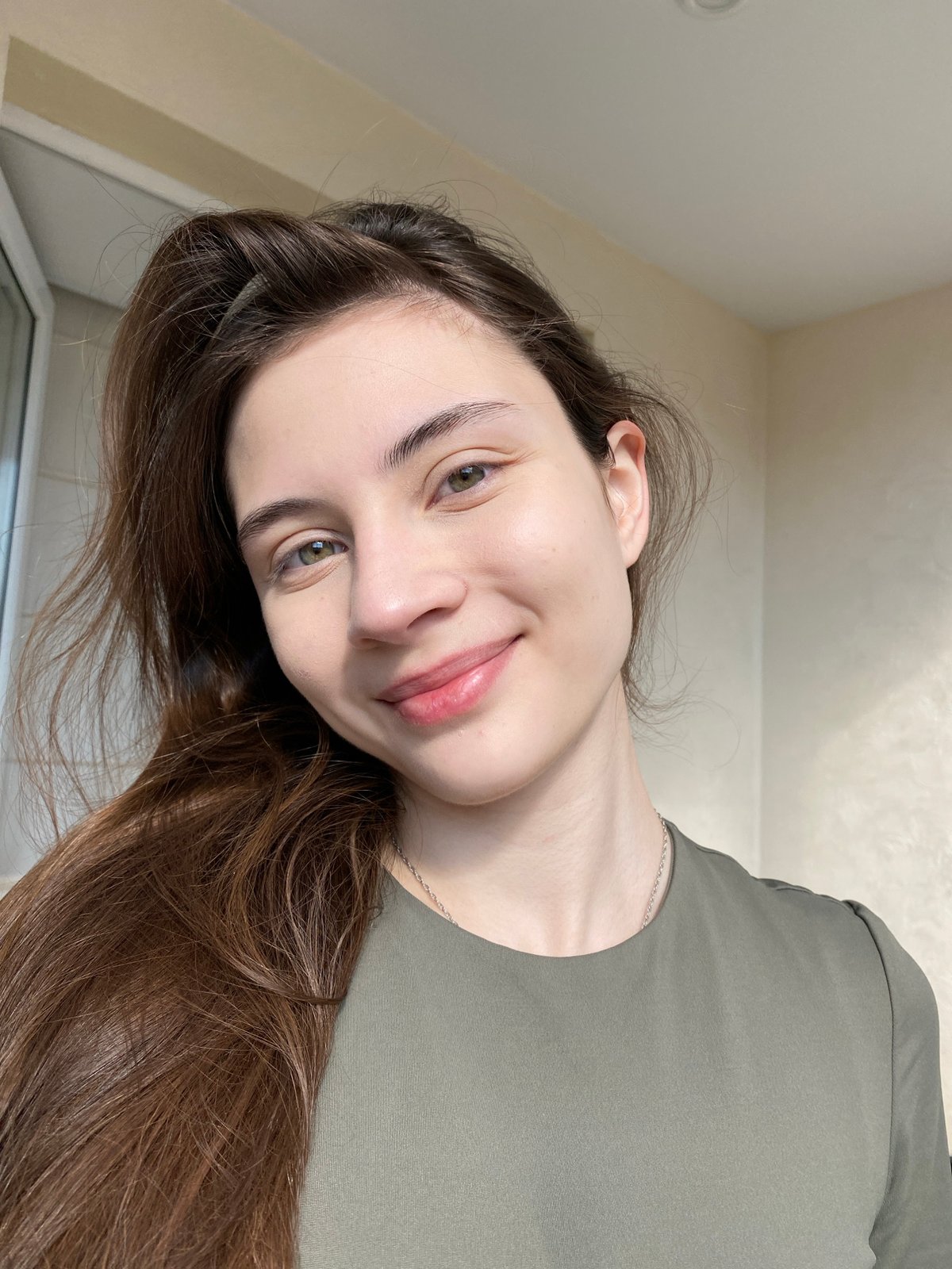 Young woman photographed in multiple indoor portraits in Votkinsk