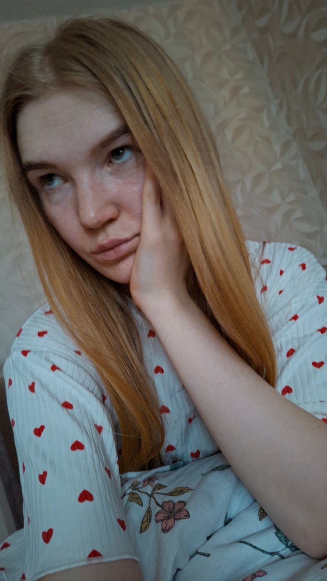 Woman in heart-patterned pajamas observed resting in Chaikovsky bedroom
