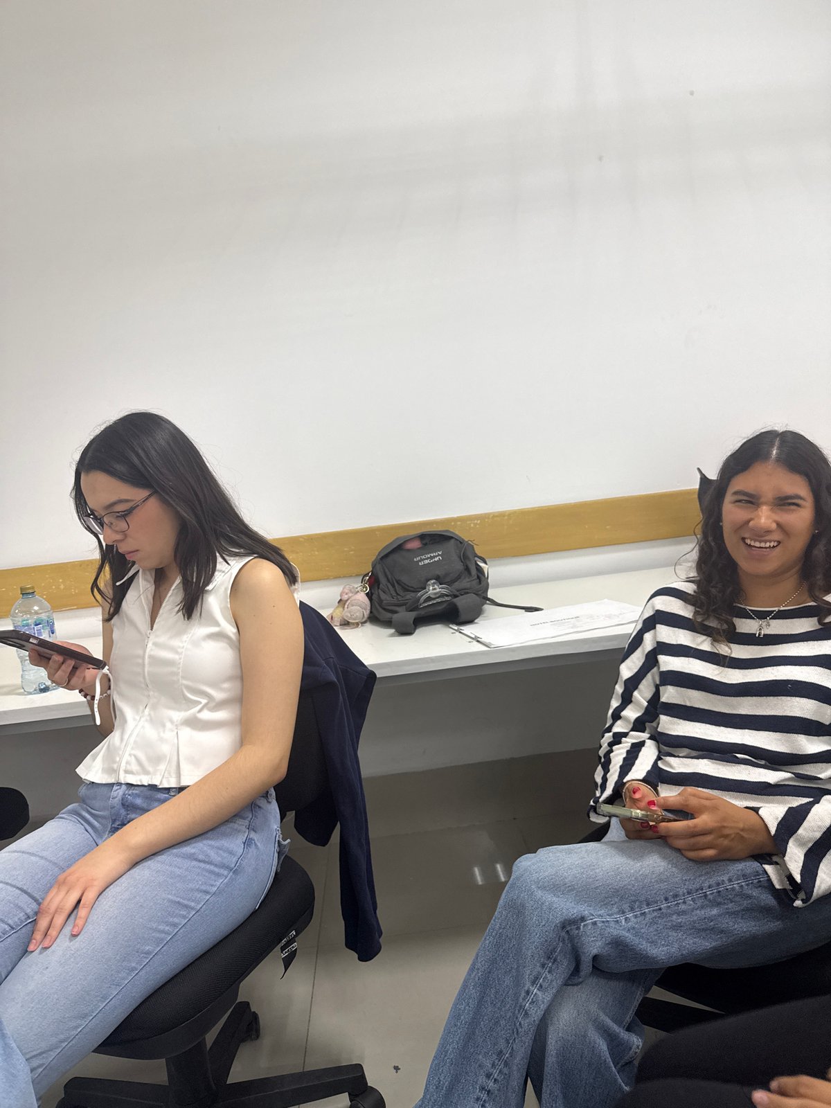 Students study construction models in classroom setting