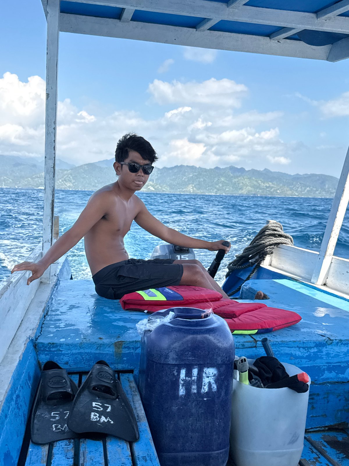 Relaxing on a blue-decked boat off the Indonesian coast