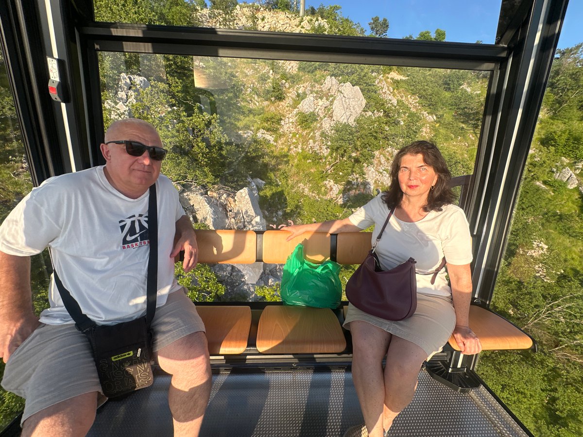 Cable car riders enjoy sunset views over Montenegro coast