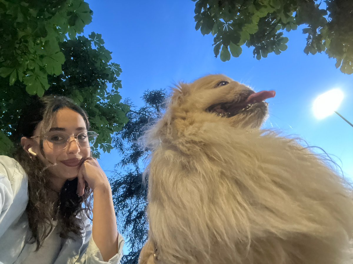 Woman walks Pekingese dog through Milan landmarks Sunday afternoon