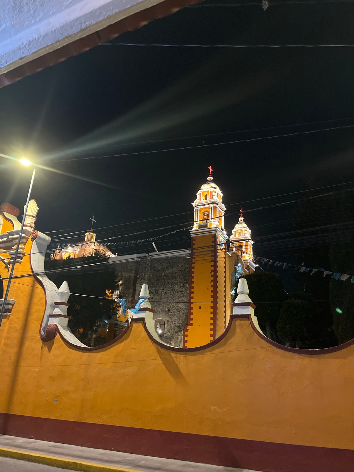 Nighttime church view captured through decorative archways in Mexico