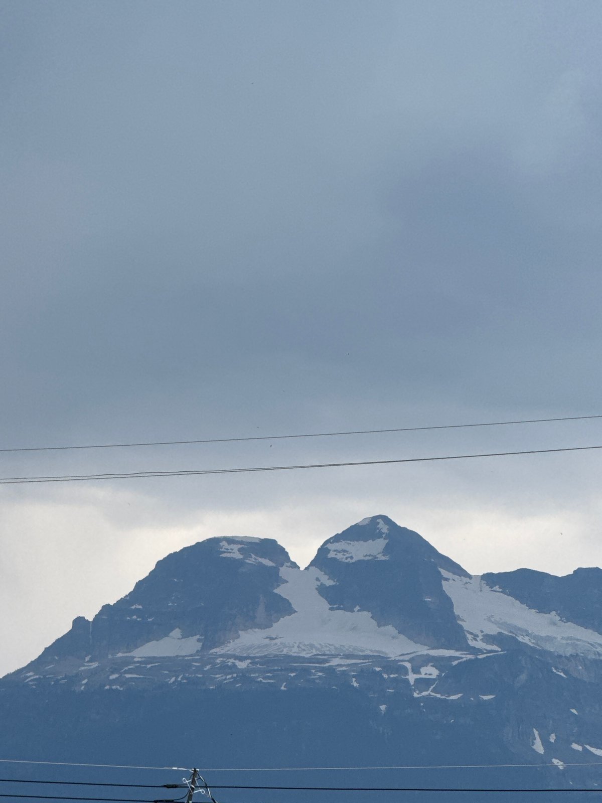 Mount Begbie's snowy peaks under a gray Revelstoke sky
