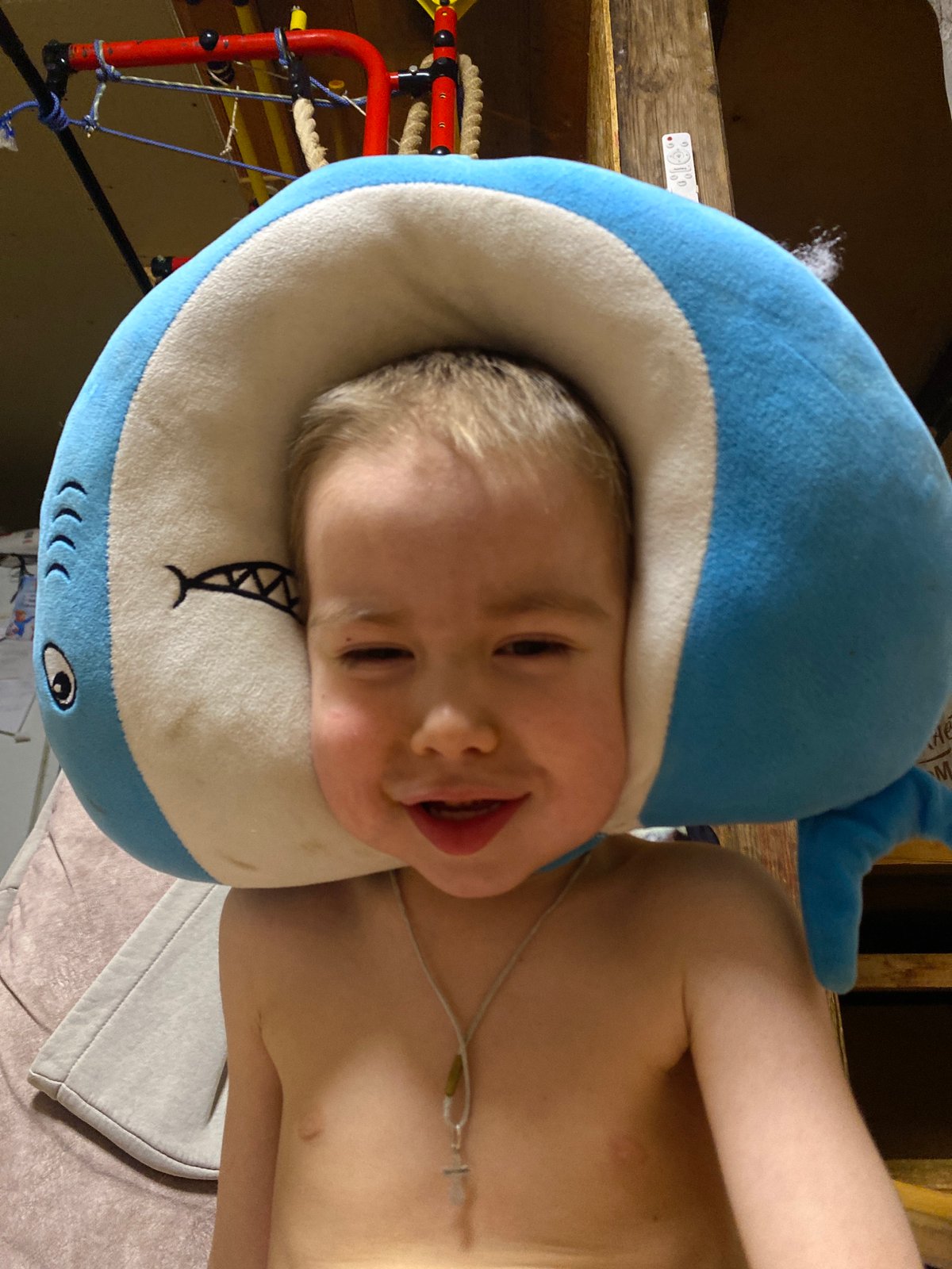Smiling toddler photographed in shark-themed pillow in Ольховка