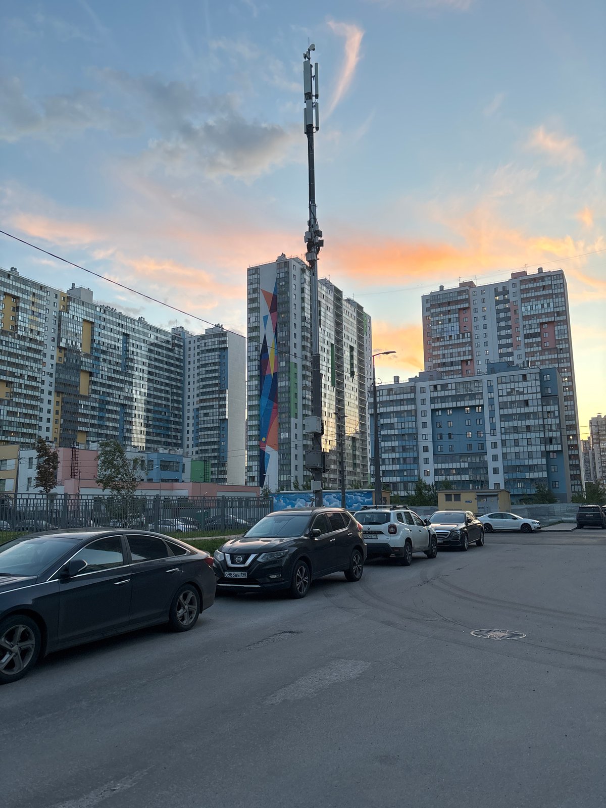Urban mural featuring female figure documented during sunset