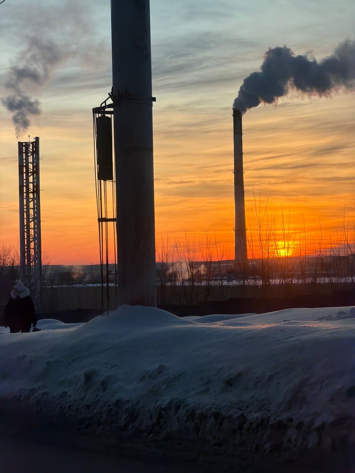 Industrial smokestacks documented at dawn in snow-covered Izhevsk