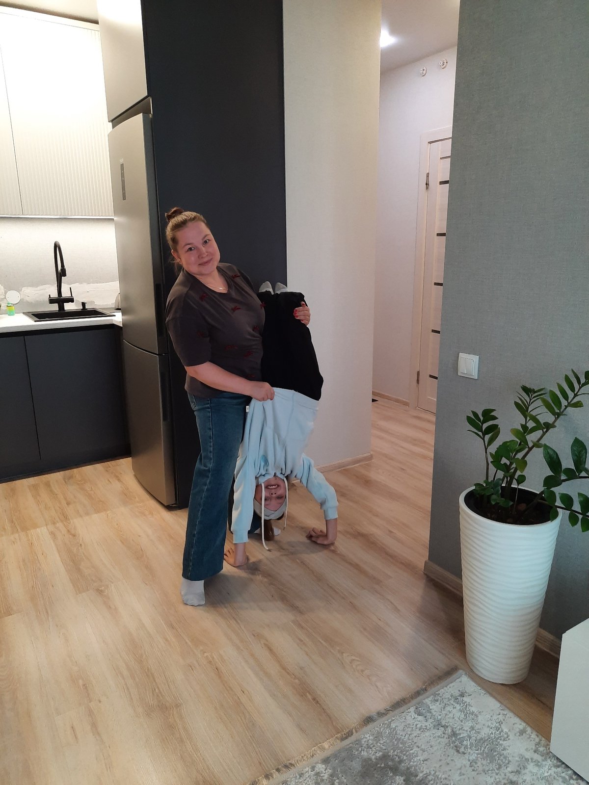 Woman and child share tender moment in Pervomaysky home