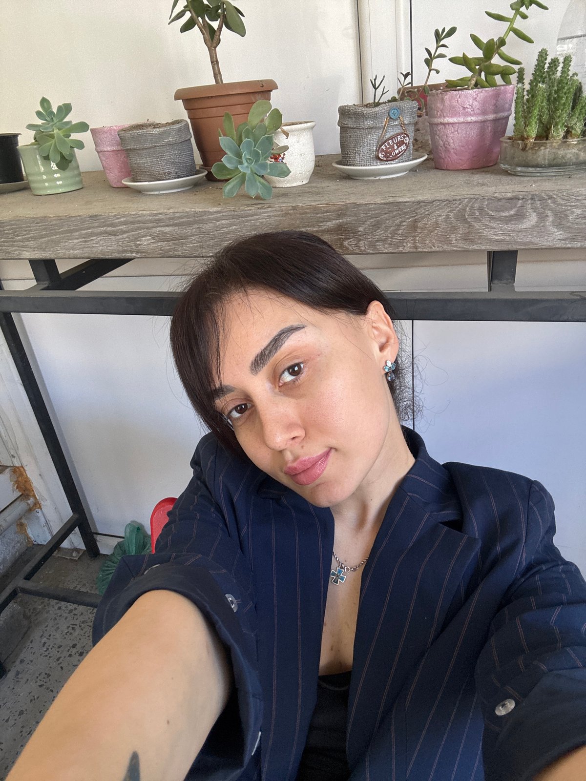 Woman photographed across multiple Tbilisi locations in navy blazer