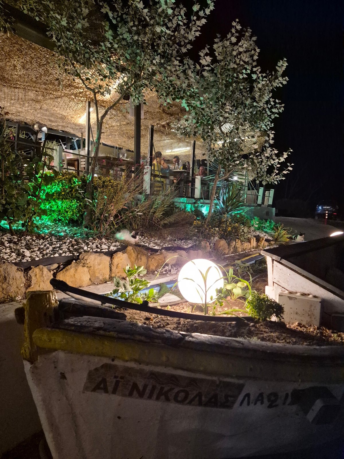Seaside taverna night in Makri under a full orange moon