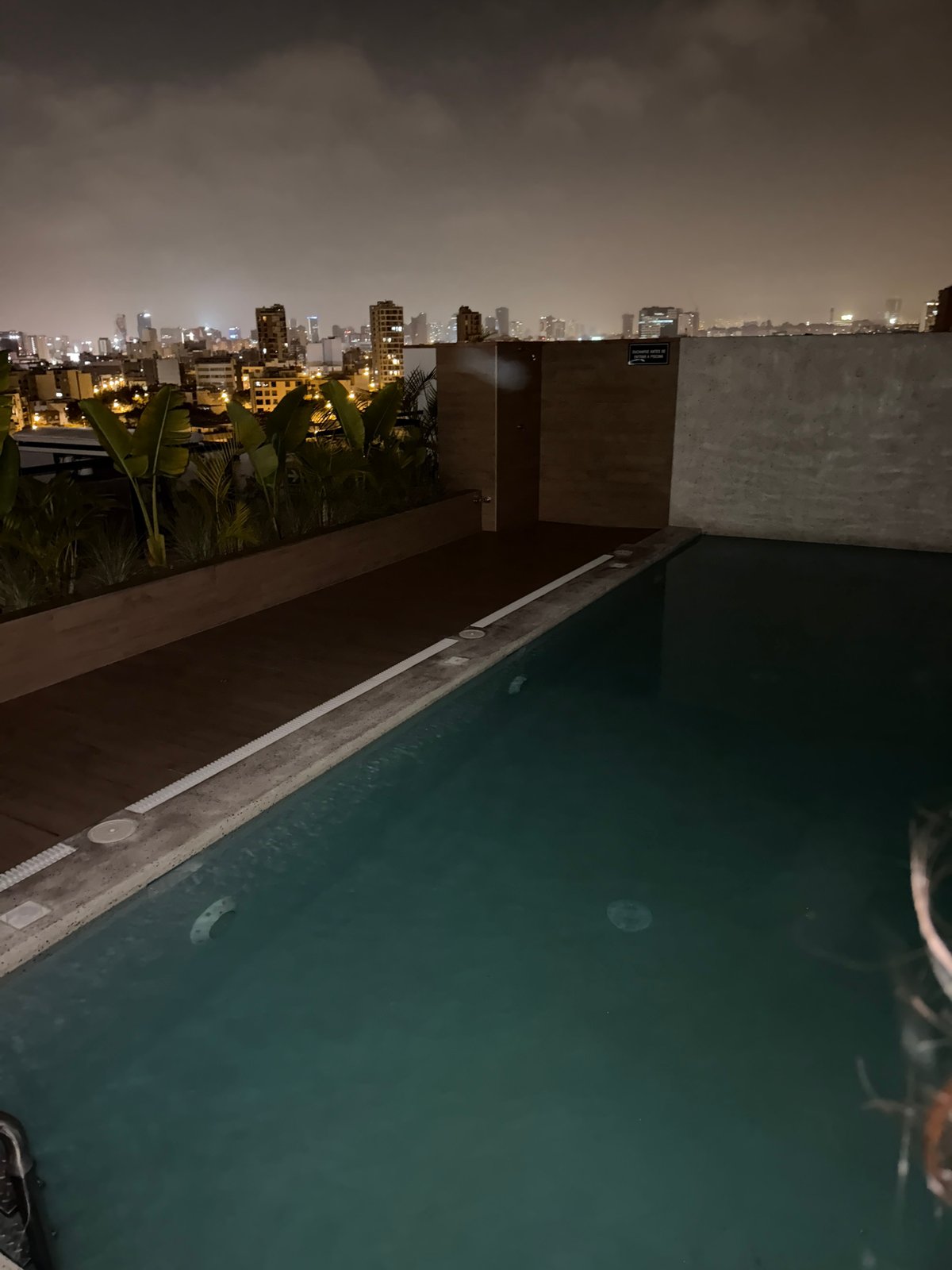 Rooftop gathering in Miraflores under crescent moon early morning