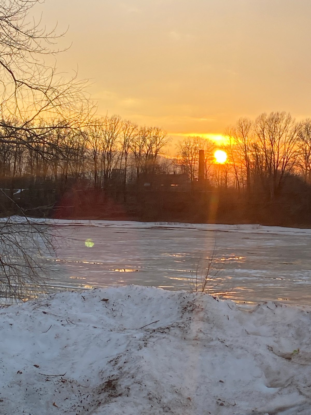 Winter sunset observed over frozen water in Chaikovsky, Russia