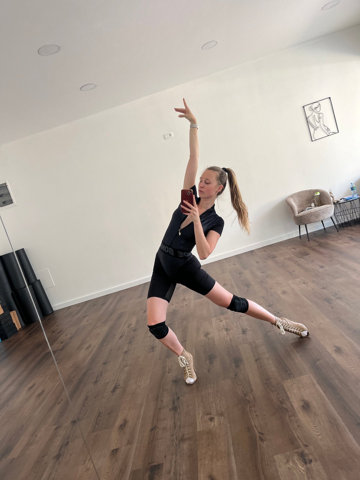Woman photographed in dynamic poses during indoor photo session