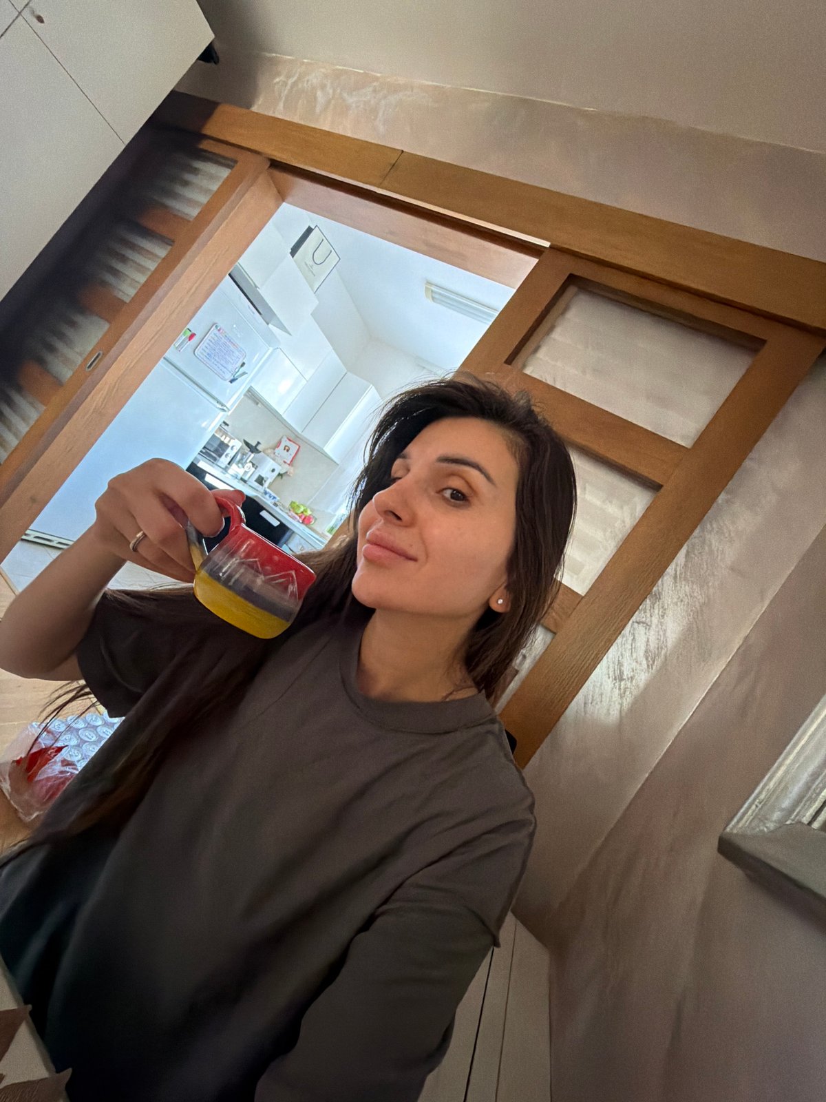 Woman holds colorful mug in Budva Montenegro kitchen