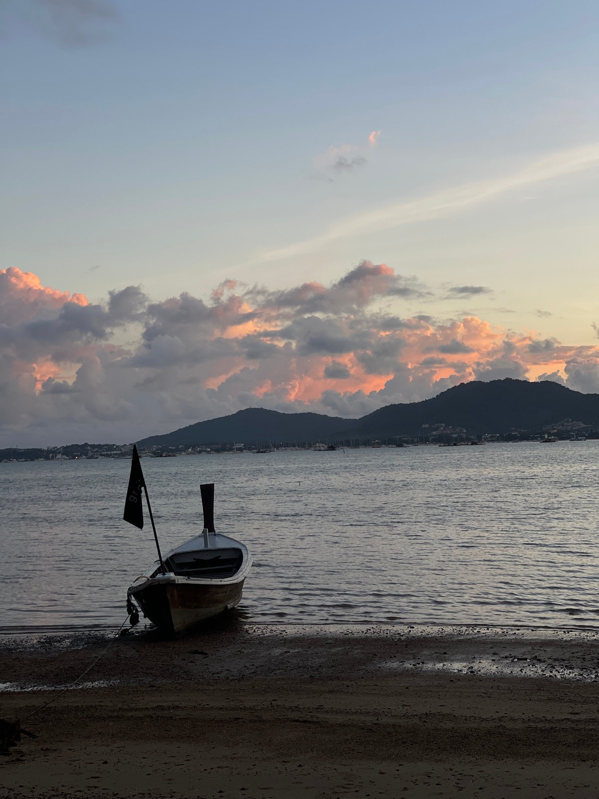 Dusk at Grove Phuket's waterfront, boats and fairy lights