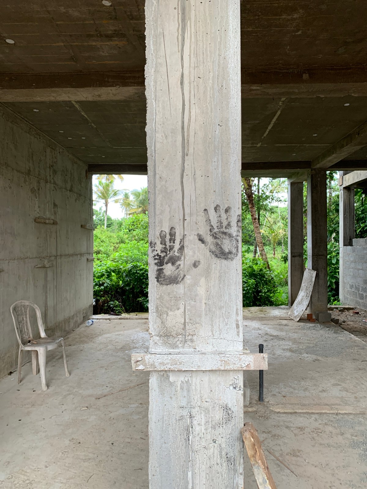 Residential property documentation includes mysterious handprints on concrete pillar