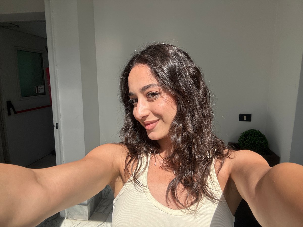 Woman takes selfies in Milan building interior