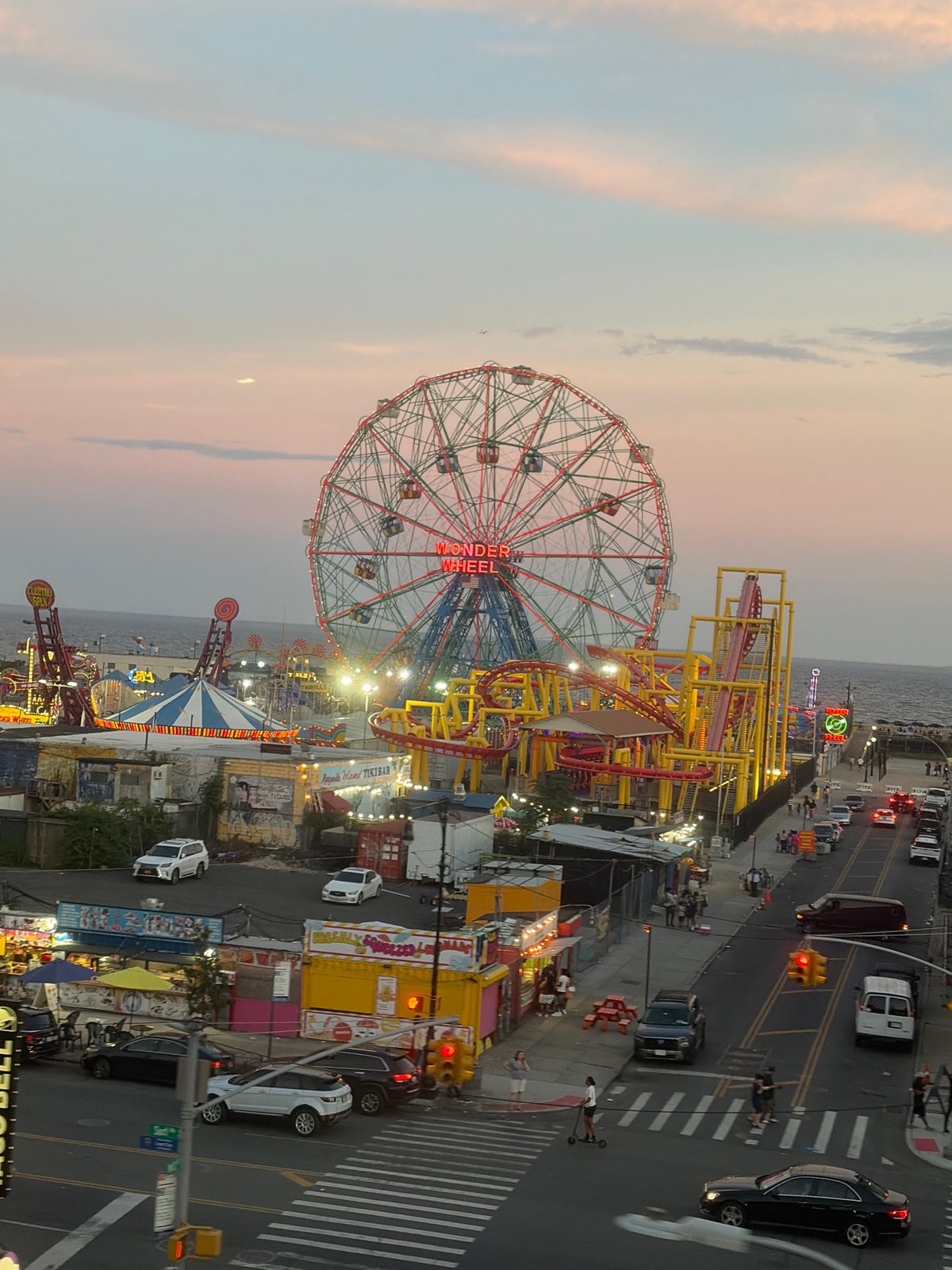 Coney Island lights up at dusk, July 2026