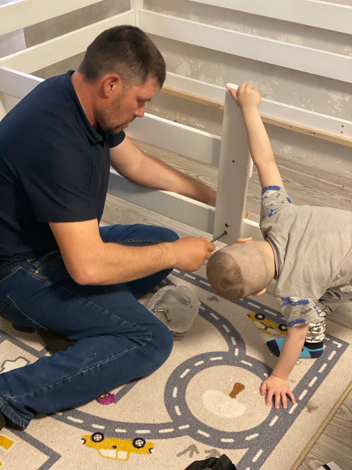 Father and child assemble furniture together in Sochi home