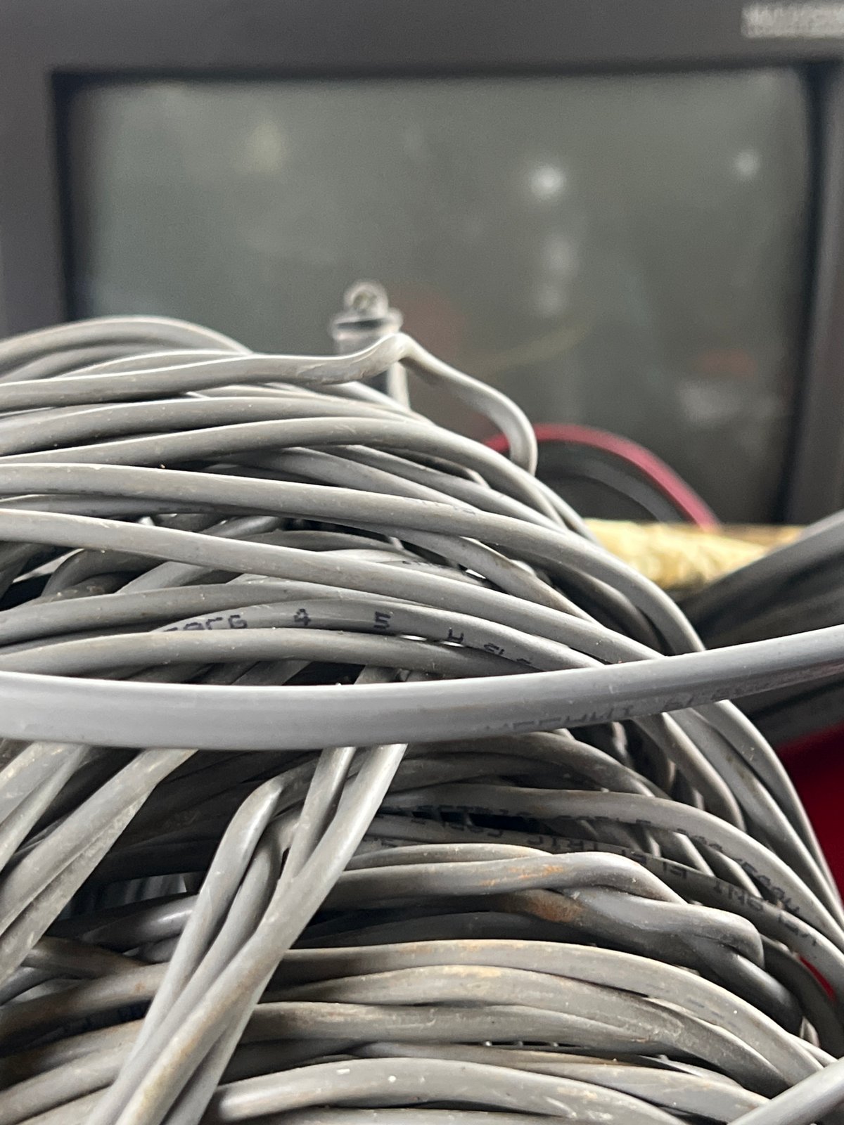 Construction site shows concrete structure, electrical cables being installed