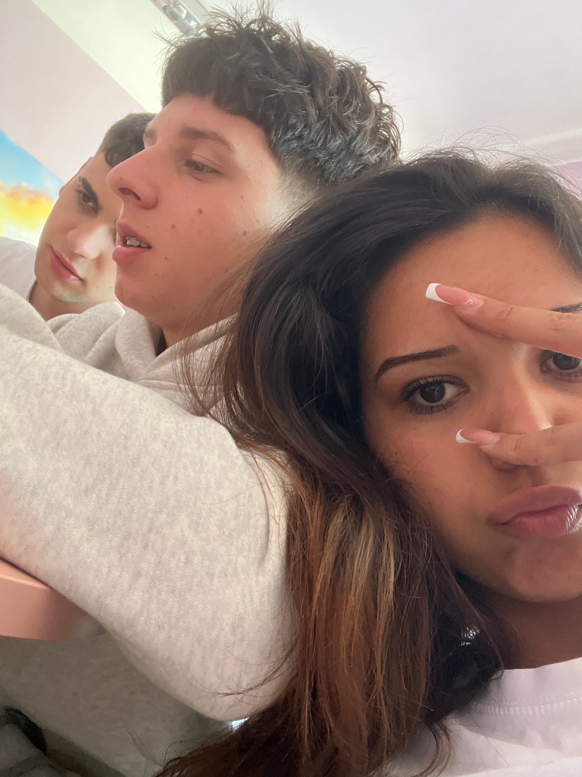 Young people take casual selfies indoors during morning hours