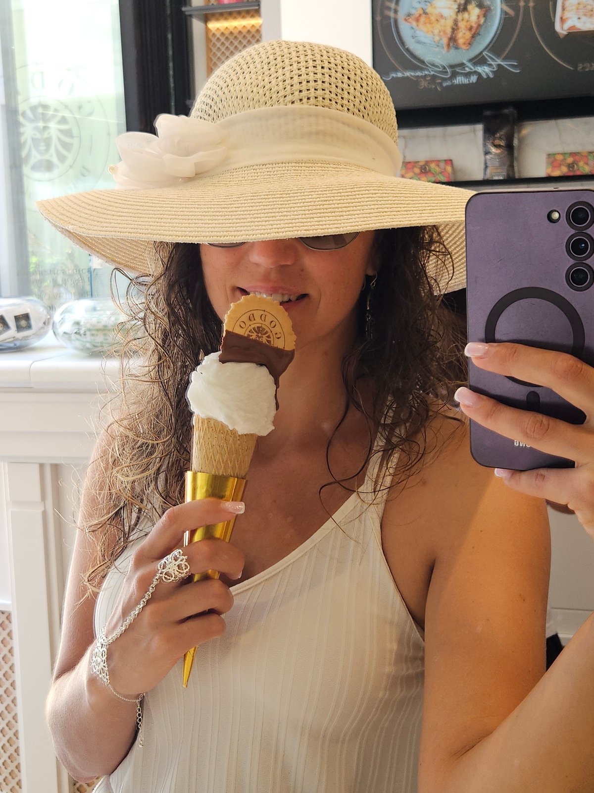 Woman takes selfie with ice cream near construction site
