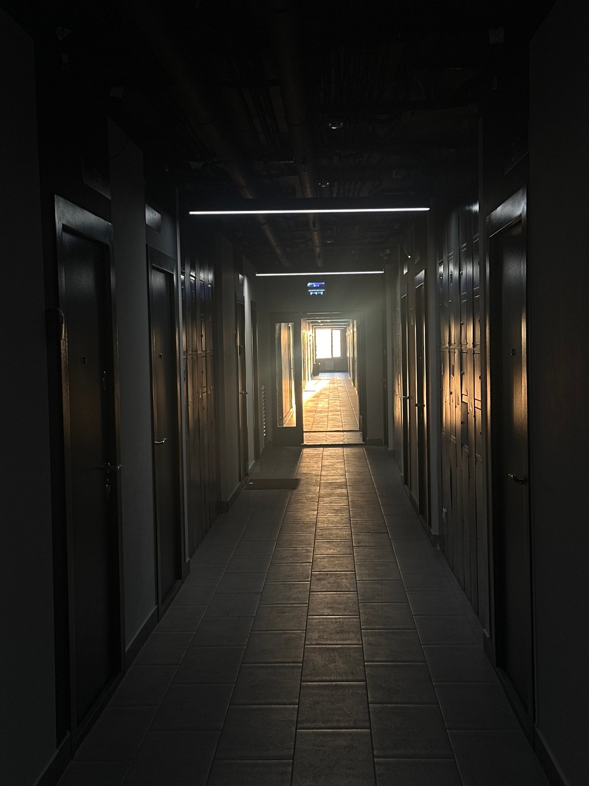 Dramatic lighting captured in tiled hallway, Khimki Russia