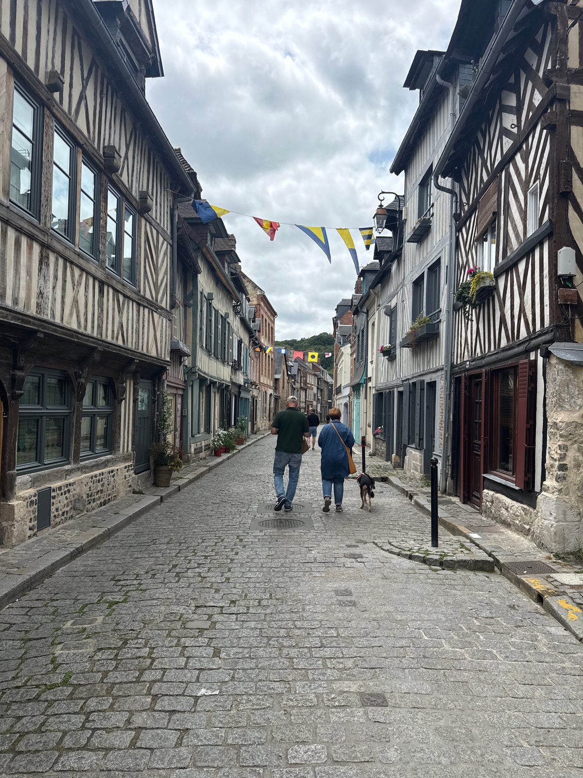 Tourist explores historic Honfleur harbor and medieval streets