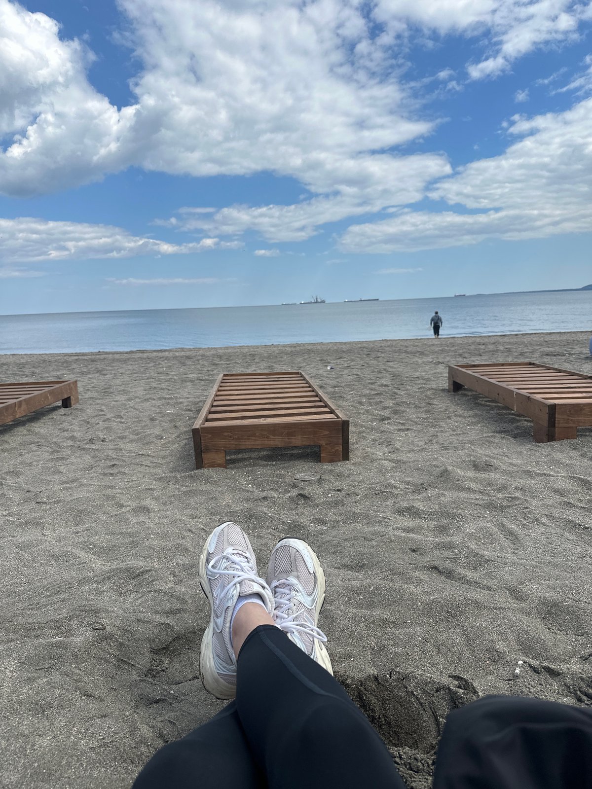 Beach moment captured from personal perspective looking toward sea
