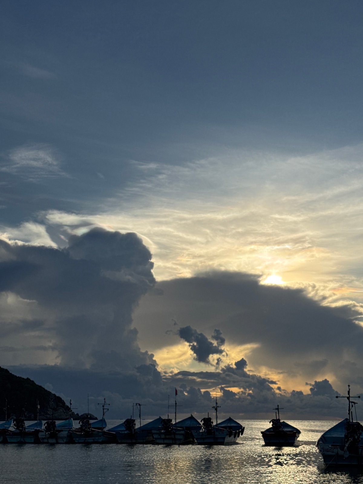 Dusk on Koh Phangan: fishing boats, beach DJ, stormy skies
