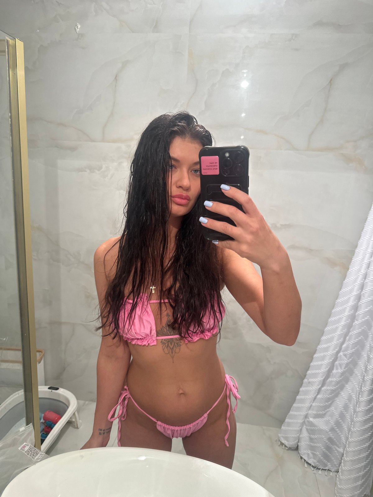Woman takes bathroom selfie in pink bikini, Moscow