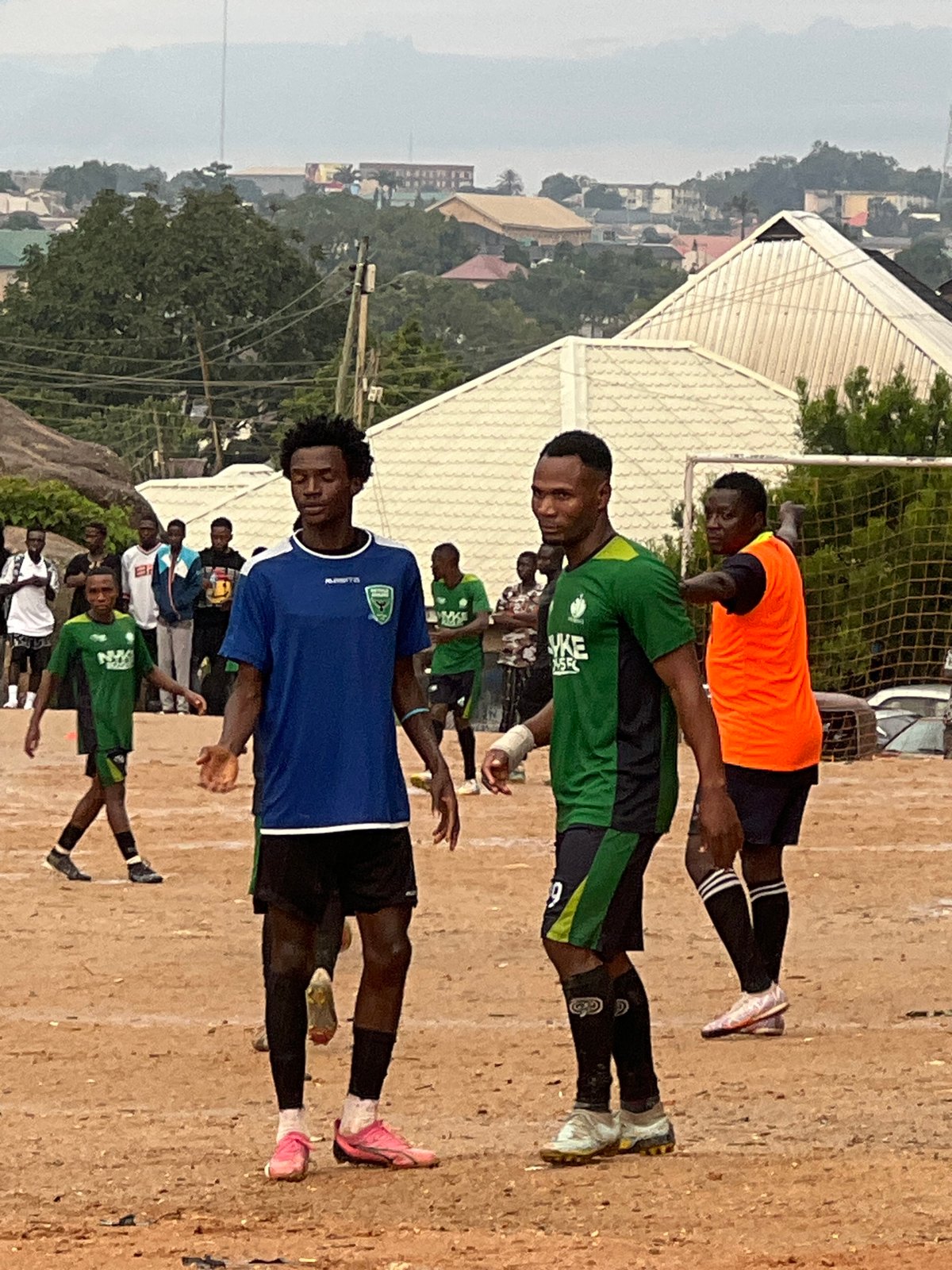 Pickup football on a Jos dirt pitch among rocky terrain