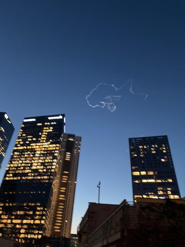 Aircraft contrail spotted over Tel Aviv twilight skyline