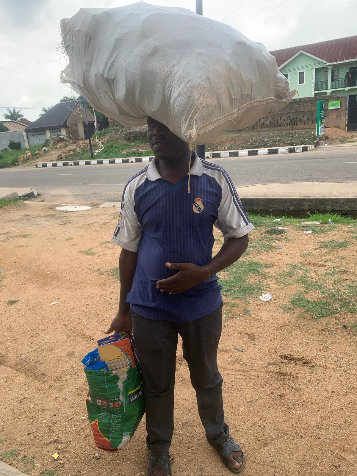 Everyday street activity across a Jos neighborhood midday
