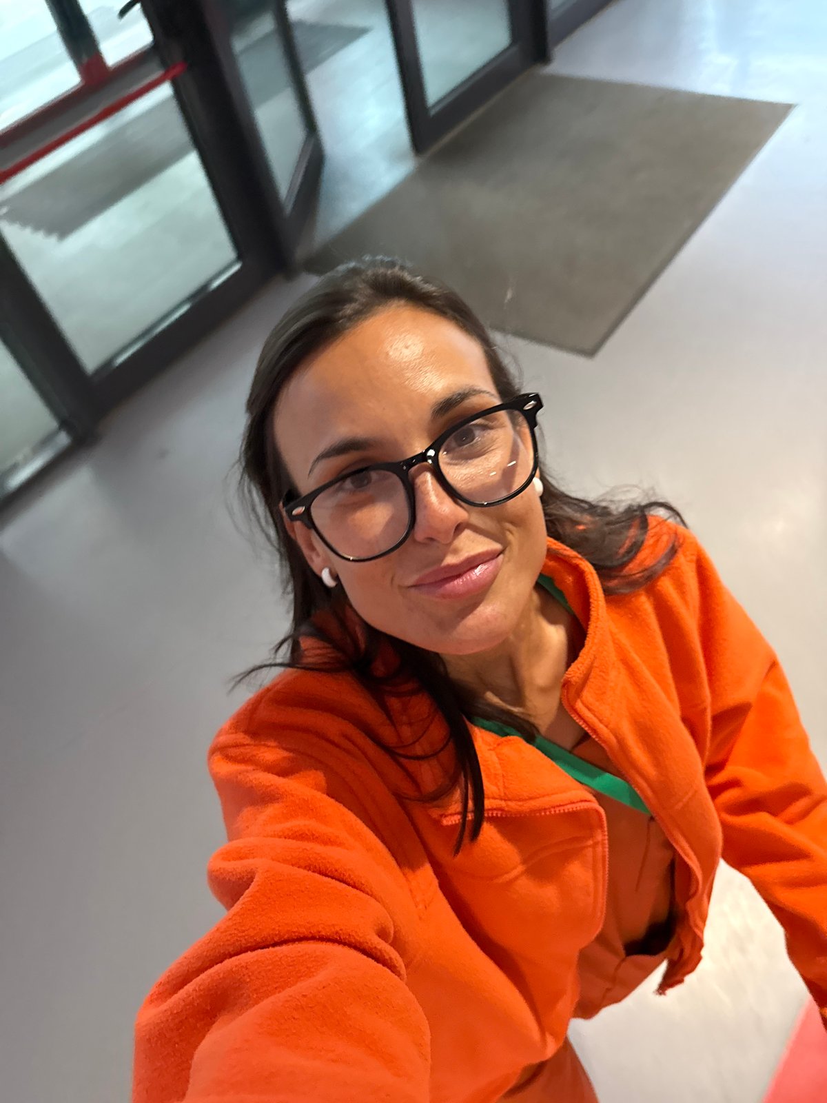 Quick selfie inside a Pleven building, orange jacket and green lanyard