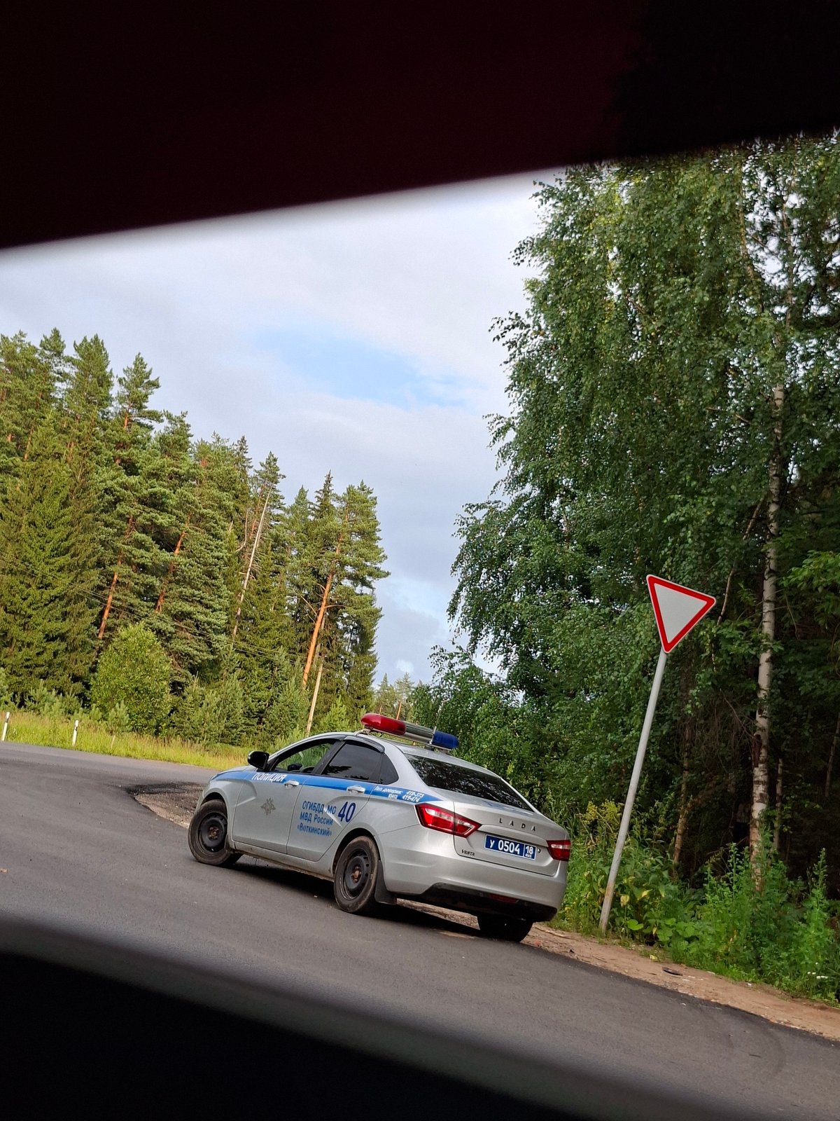 Police stop on a forested road in Votkinsk, kids watching from inside