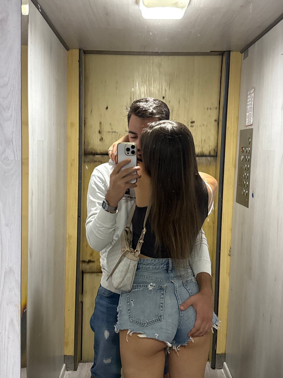 Couple's mirror selfie session documented across Sofia apartment