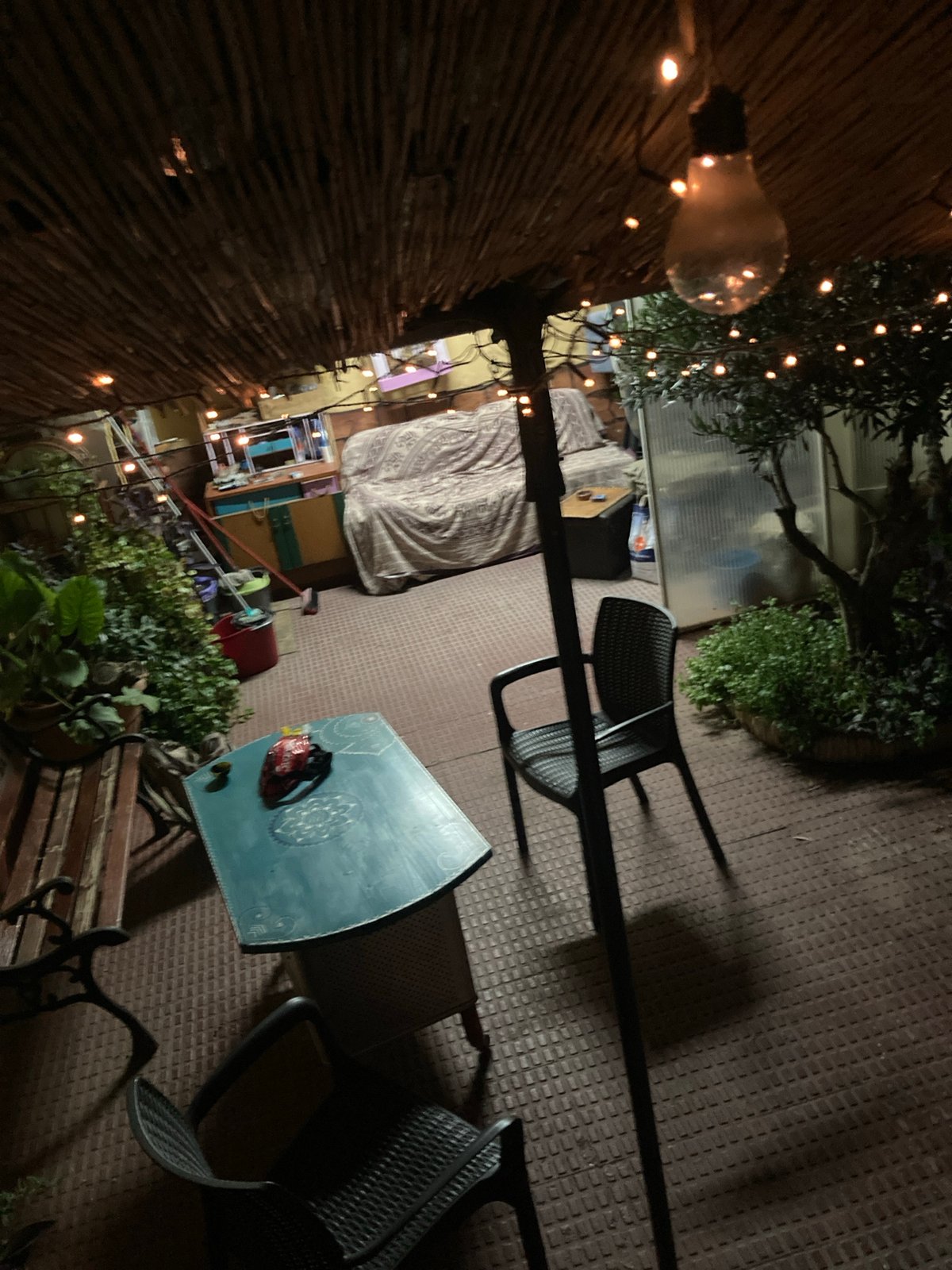 Warm-lit thatched patio bar at night in Sabadell